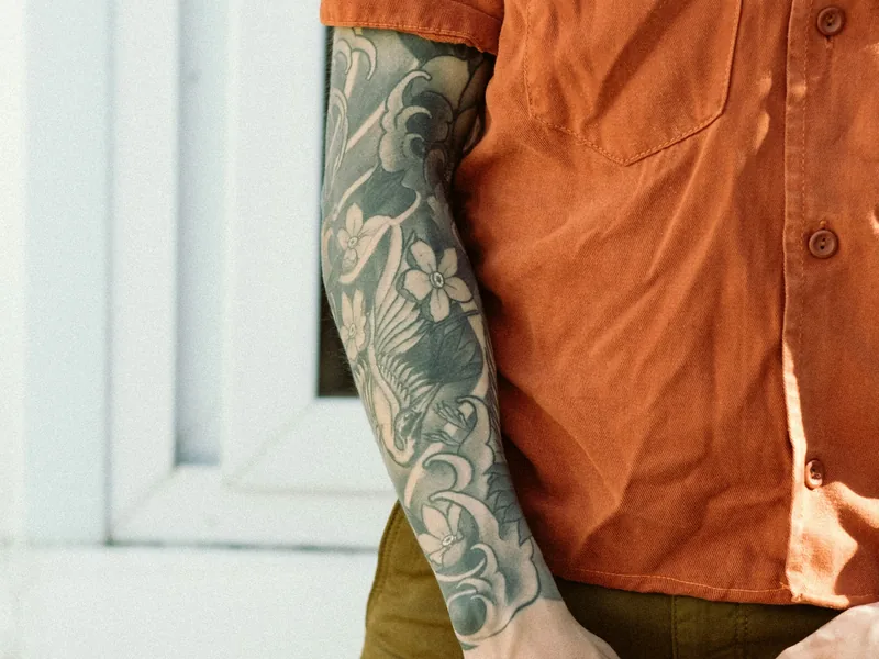 Black and grey sleeve on a man's arm