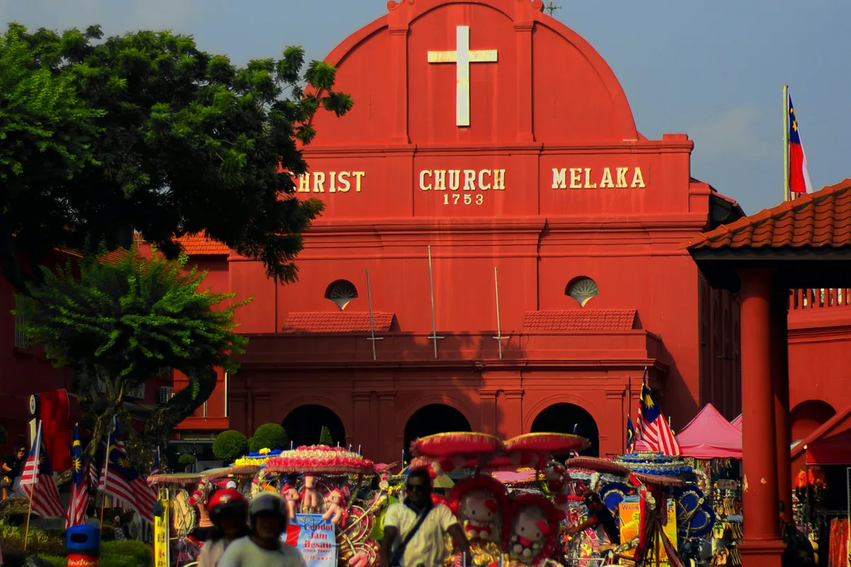 Christ Church and trishaws at Red Square, about five minutes on foot from the Jonker Street tattoo shop in Melaka