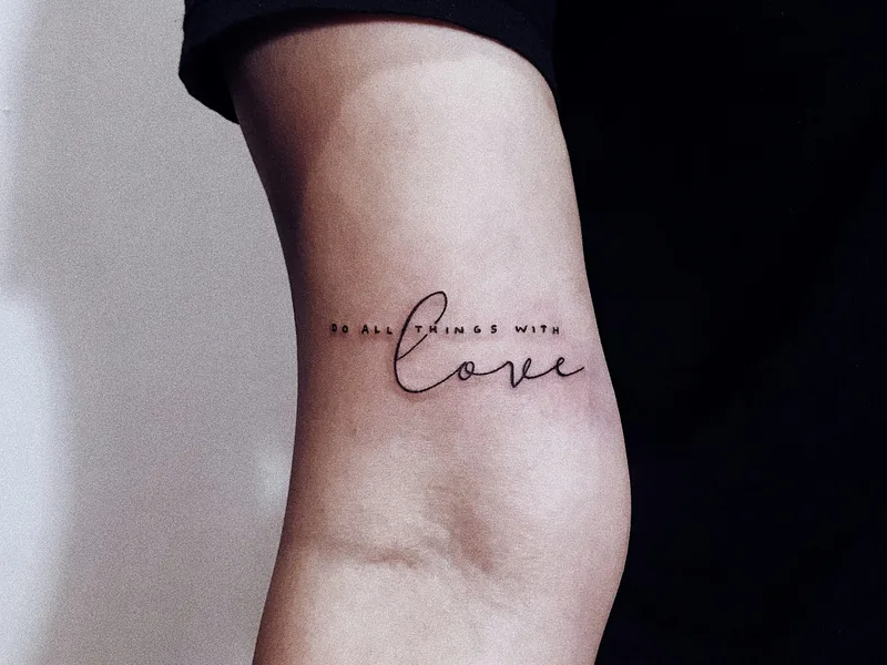 Delicate fine line script tattoo on the back of an arm