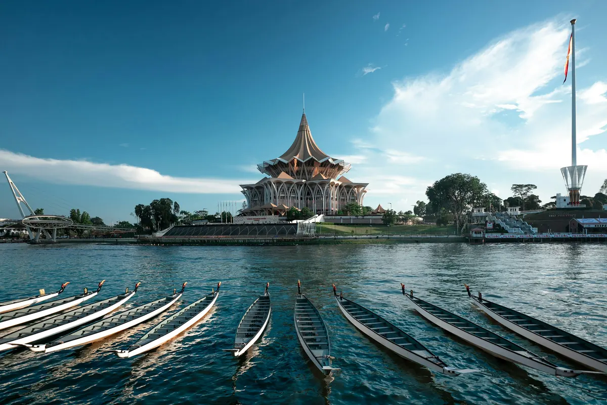 Longboats moored on the Sarawak River near Kuching tattoo studios in old Chinatown
