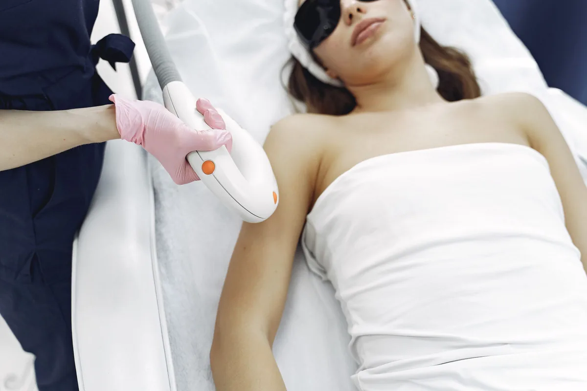 Patient wearing protective eyewear during a laser session, as in tattoo removal at Johor Bahru clinics