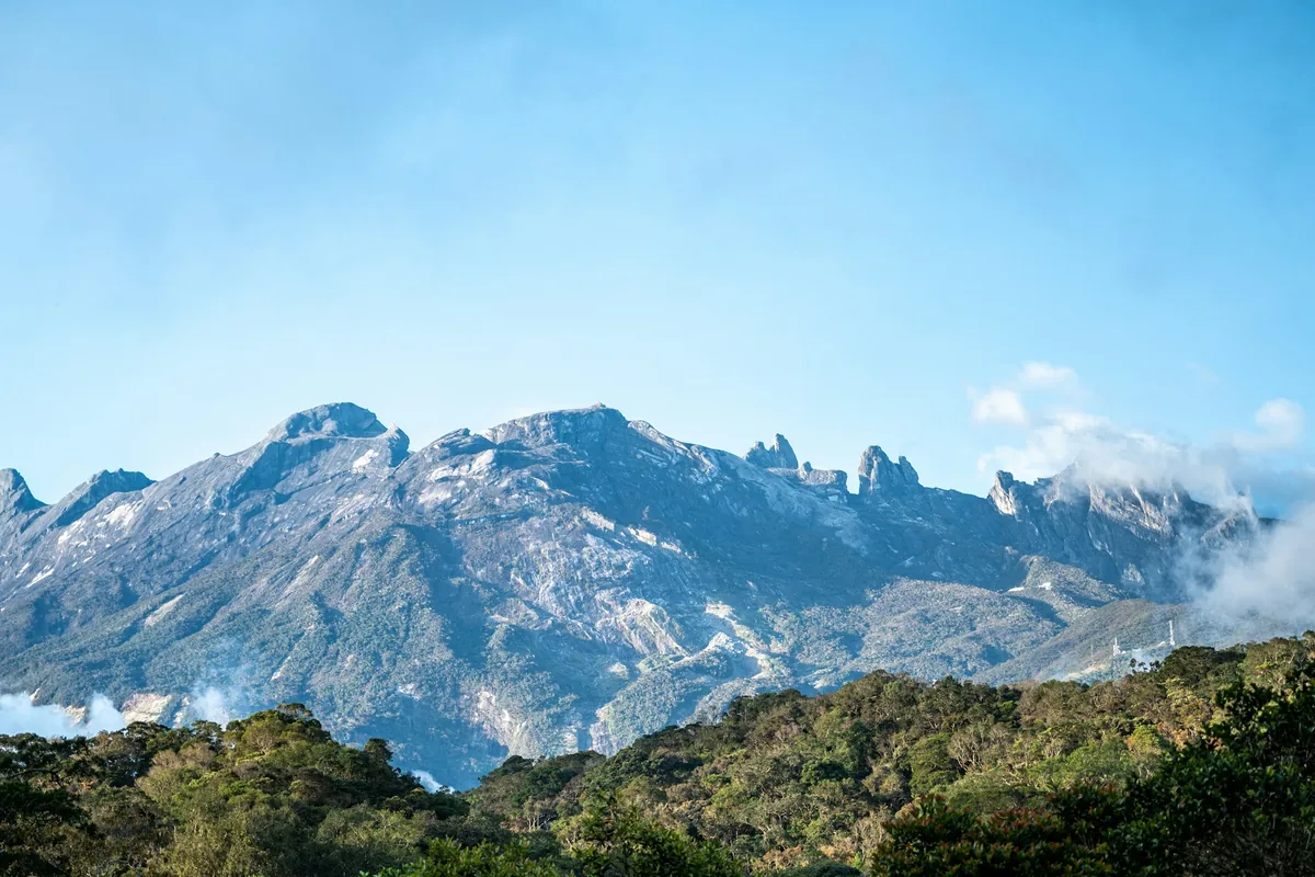 Mount Kinabalu rising above the forest in Sabah, a day trip from tattoo studios in Kota Kinabalu