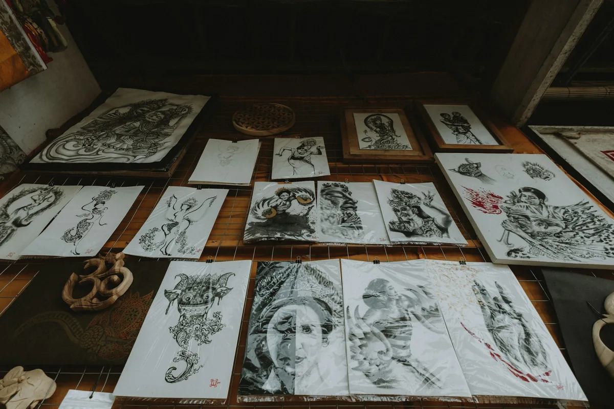 Tattoo flash drawings and design ideas laid out on a table