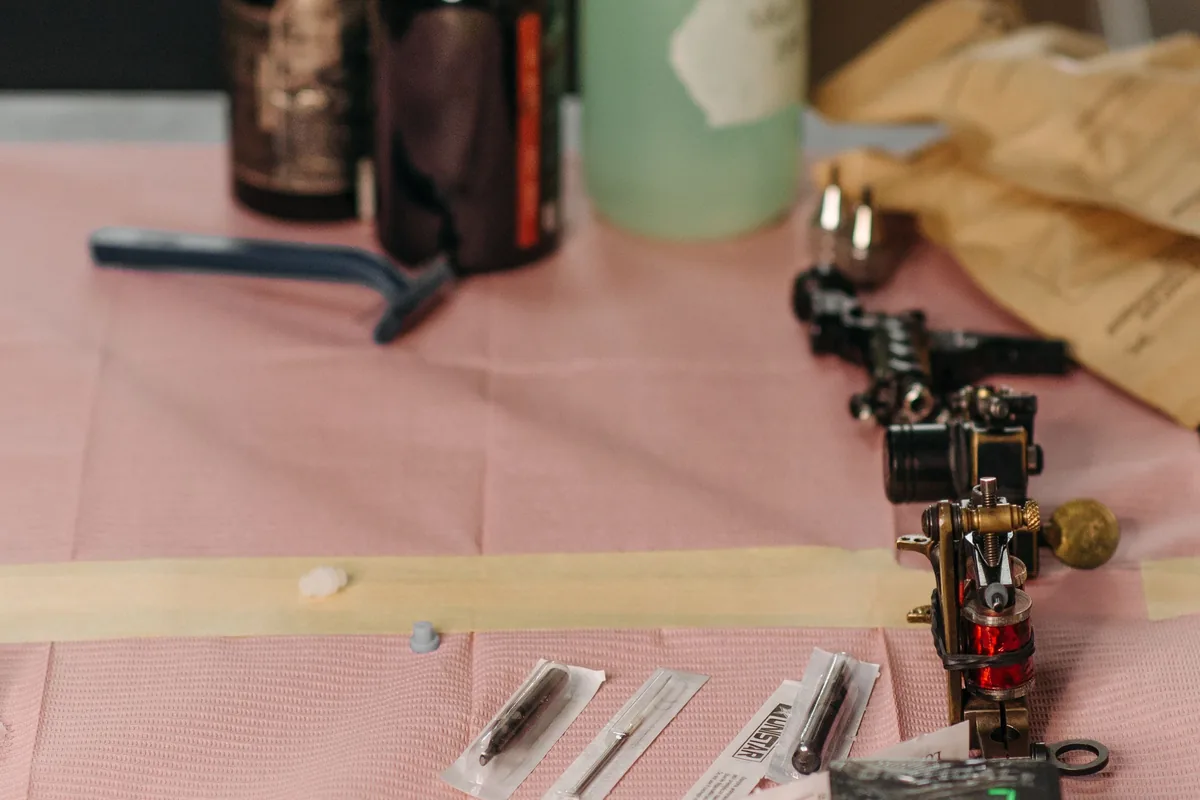 Sterile needle cartridges and supplies laid out at a tattoo shop station, the setup to look for in Malaysia