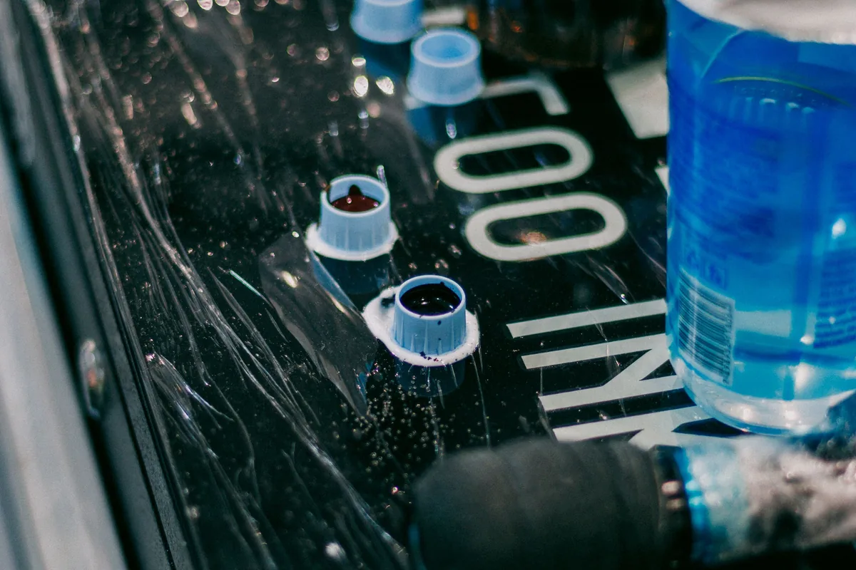 Ink cups and a machine on a station covered in barrier film, a sign of good hygiene for any tattoo in Kuantan